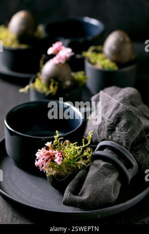 Easter table setting with empty black ceramic tableware Stock Photo
