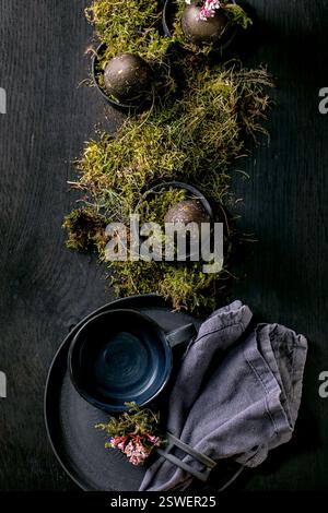 Easter table setting with empty black ceramic tableware Stock Photo