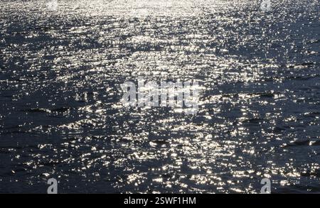 Sunbeams reflect glittering on water surface with high waves, Abstract background, Graphic elements, Mondsee, Salzkammergut, Austria, Europe Stock Photo
