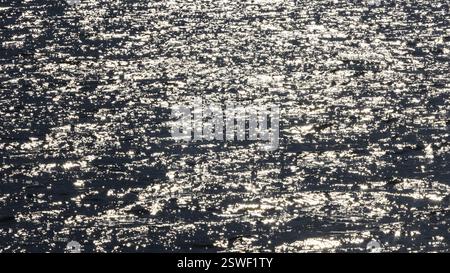 Sunbeams reflect glittering on water surface with high waves, Abstract background, Graphic elements, Mondsee, Salzkammergut, Austria, Europe Stock Photo