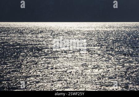 Sunbeams reflect glittering on water surface with high waves, Abstract background, Graphic elements, Mondsee, Salzkammergut, Austria, Europe Stock Photo