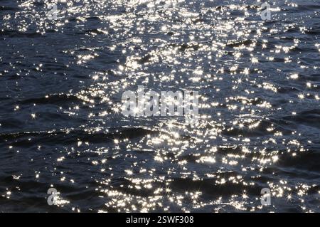 Sunbeams reflect glittering on water surface with high waves, Abstract background, Graphic elements, Mondsee, Salzkammergut, Austria, Europe Stock Photo