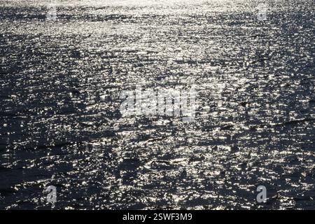 Sunbeams reflect glittering on water surface with high waves, Abstract background, Graphic elements, Mondsee, Salzkammergut, Austria, Europe Stock Photo