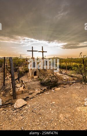 Sunset Over Abandoned Desert Cemetery With Crosses and Stone Graves Under Dramatic Sky Stock Photo