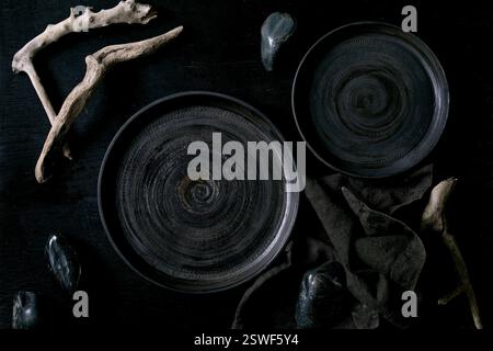 Empty black ceramic plates with black stones Stock Photo