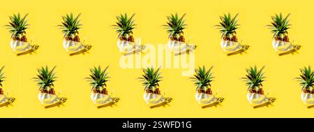 Many pineapples on a solid yellow background pattern Stock Photo
