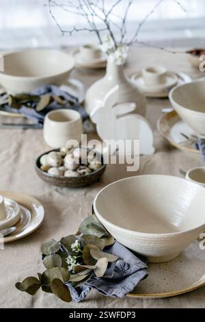 Easter dinner table setting with ceramic tableware Stock Photo