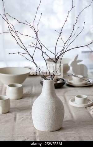 Spring birch branches in white ceramic vase Stock Photo