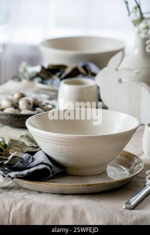 Easter dinner table setting with ceramic tableware Stock Photo