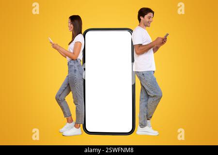 Couple leaning on white empty smartphone screen and using phone Stock Photo