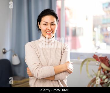 Waist-up portrait of positive woman at home Stock Photo