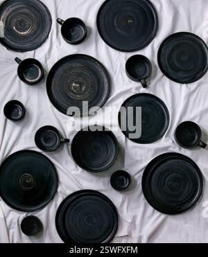 Set of empty black handcrafted ceramic plates Stock Photo