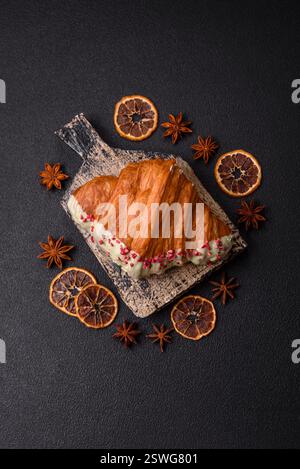 Crispy sweet red croissant with pistachio, raspberry and strawberry Stock Photo
