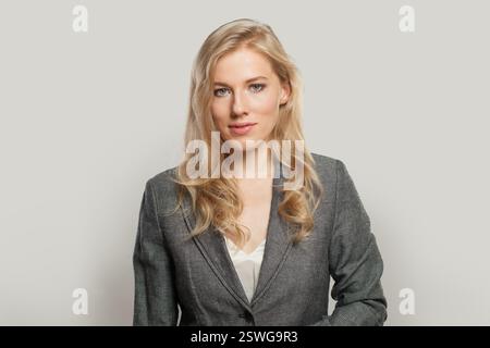 Portrait of nice business woman in suit looking at camera Stock Photo