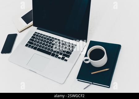Workplace with laptop, notepad and coffee cup on white background Stock Photo