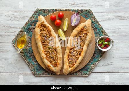 Arabic pizza Lahmacun on white wooden background. Stock Photo