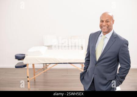 Confident professional in a suit standing in medical office Stock Photo