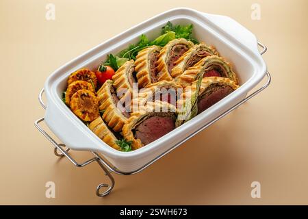 baked meatloaf in puff pastry with vegetables Stock Photo