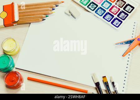 Creative workspace for artists featuring tools, paints, and blank canvas ready for inspiration at a sunny afternoon Stock Photo