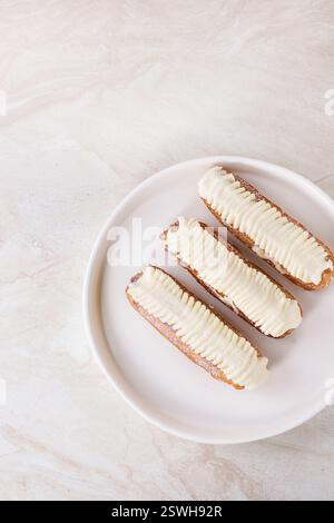 Eclairs on white marble Stock Photo
