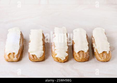 Eclairs on white marble Stock Photo