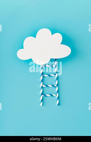 Step ladder made of paper drinking straws leading to cloud made of white paper card note on light pastel blue background. Minimal concept. Stock Photo