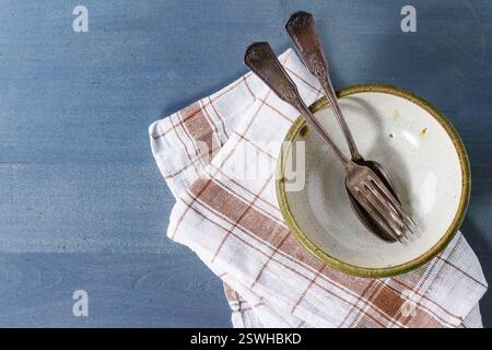 Empty ceramic bowl and cutlery Stock Photo
