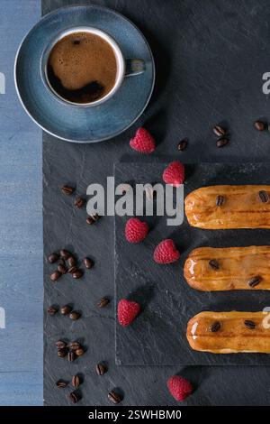 Coffe eclair with raspberries Stock Photo