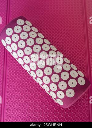 Close up massage acupuncture mat with pillow and white massage tips, massage mat for relaxation and treatment Stock Photo