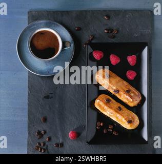Coffe eclair with raspberries Stock Photo