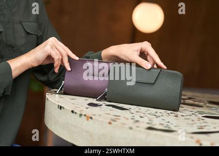 Stylish selection of elegant leather wallets, in purple and green, on speckled surface, showcasing modern accessory concept Stock Photo