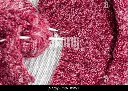 yarns, knitting needles and pattern sample on grey background. closeup Stock Photo