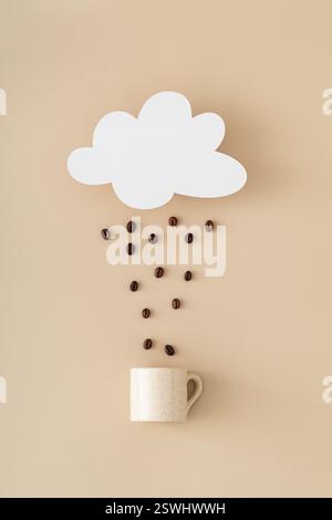 Creative layout made of cloud shape paper card note, coffee beans rain and coffee cup on beige background. Minimal concept. Trendy weather idea. Stock Photo
