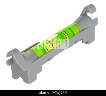 Very small line level that is designed to go on a piece of twine that has a green and yellow indicator isolated on a white background. Stock Photo