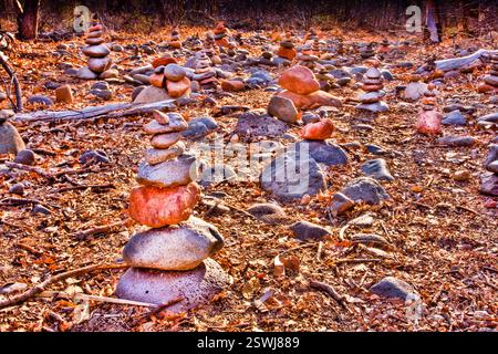 Pile of rocks with a few stacked on top of each other. The rocks are brown and gray Stock Photo