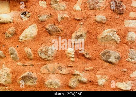 Background with red wall and big stones Stock Photo