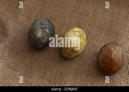 three easter eggs on a burlap texture background Stock Photo