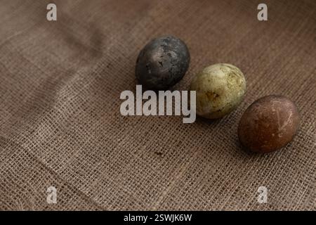 three easter eggs on a burlap texture Stock Photo