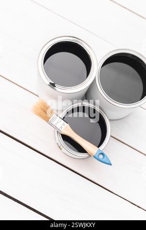 Top view of metal cans with paint on white wooden background Stock Photo