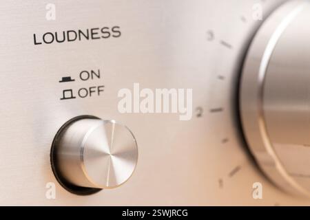 Detailed image of a close-up view of a stereo control panel featuring a rotating knob and loudness functionality, representing technical design and vo Stock Photo