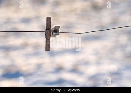Wooden clothespins on a rope. Stock Photo