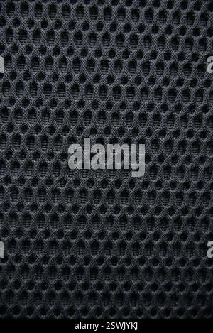 Close up texture of dark breathable mesh fabric Ideal for sportswear or upholstery Stock Photo