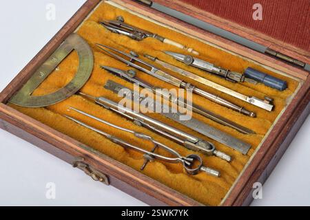 Antique technical drawing set  in steel and brass with compass, nibs and protractor in wooden box Stock Photo