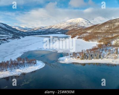 aerial photo over the winterly landscape of Lysbotnvatnet with Nerstraumen bridge on the island of Senja in Northern Norway Stock Photo