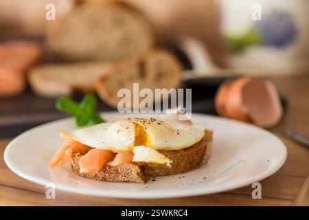 Diet breakfast with cooked egg and lightly salted red fish. Stock Photo