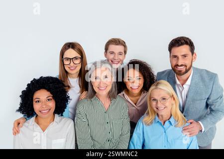 Diverse business group teamwork concept featuring coworkers in formalwear against grey background Stock Photo