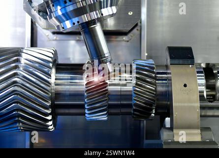 Fastest CNC lathe machine forming cutting the metal Gear Driven parts. The hi-technology metal working Stock Photo