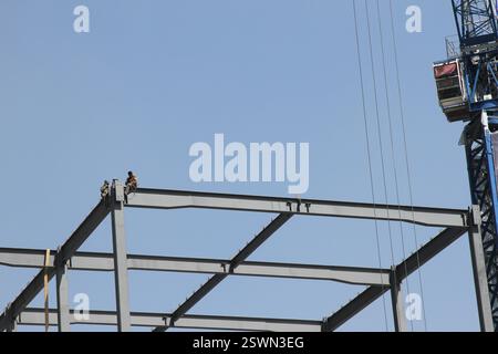 Mexico City, Mexico- 06.15.2017: Two construction workers taking a break in the heights. Stock Photo