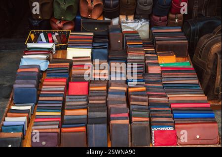 handmade leather wallets, belts and accessories on a counter at a street market in Vietnam in Asia Stock Photo