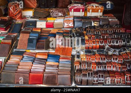 handmade leather wallets, belts and accessories on a counter at a street market in Hoi An in Vietnam in Asia Stock Photo